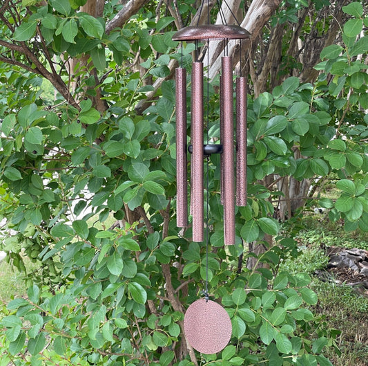 Memorial windchime with a cluster of metal tubes and a keepsake chamber at the top