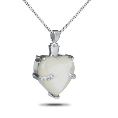 Stainless steel keepsake with a pale iridescent marble inlay set flush into the face
