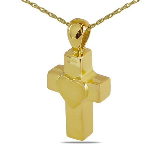 Gold cremation pendant shaped as a cross with a raised heart across its center