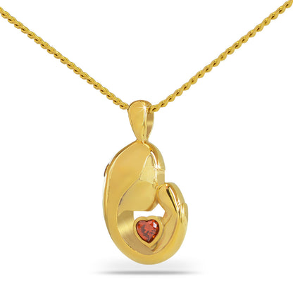 Gold heart pendant with a deep red stone and Mother's Love lettering on the front
