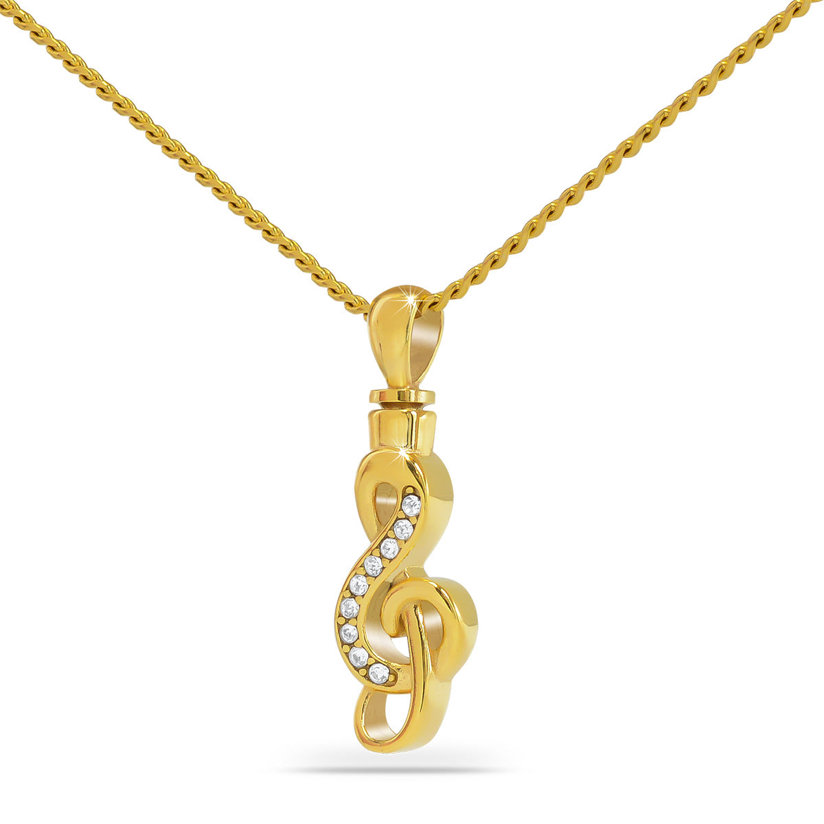 Gold-toned steel pendant with a treble clef and musical notes raised on the face