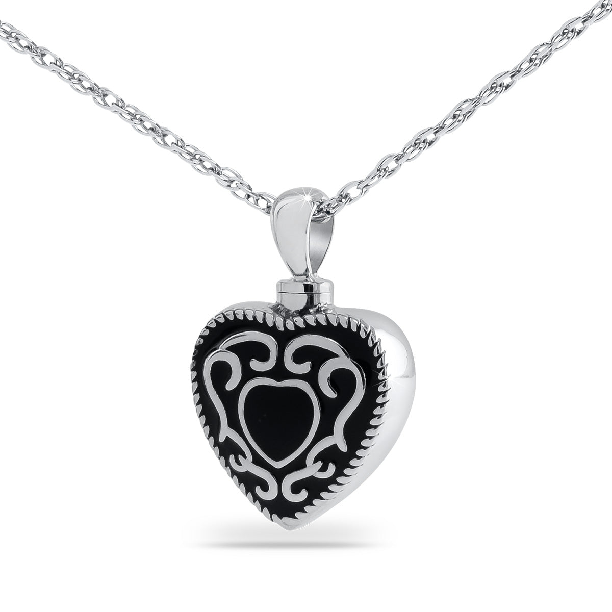 Matte black steel heart keepsake urn with western scrollwork tooled into the front