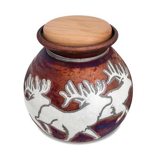 Raku ceramic cremation urn with a moose and treeline motif over a crackled glaze