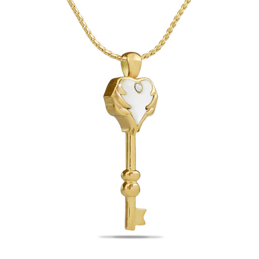 Gold-toned steel keepsake shaped as a heart with a small key and a white stone