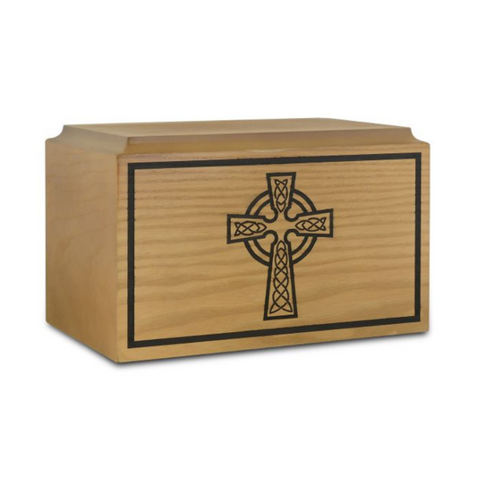 Light-toned wood cremation urn with raised Celtic cross knotwork on a low case