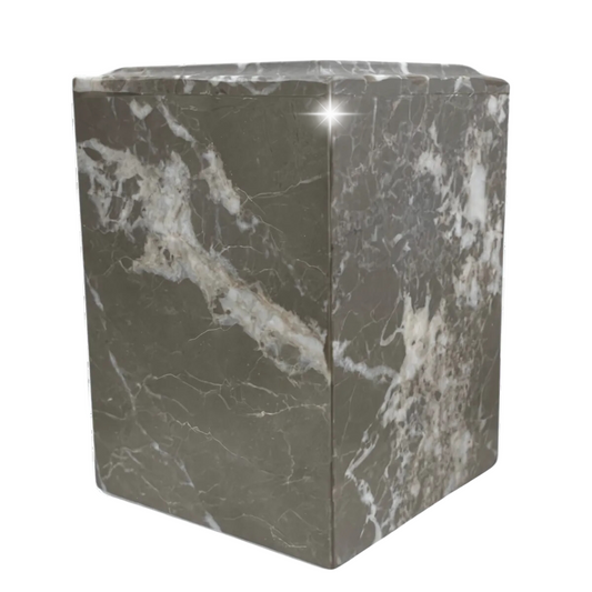 Small rectangular stone cremation urn in brown and rust tones with visible banding