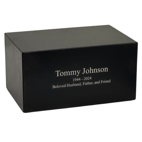 Low black metal cremation urn, wider than it is tall, with a matte finish
