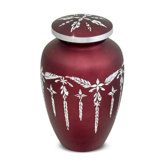 Deep red aluminum cremation urn with bands of diamond-cut faceting around the body