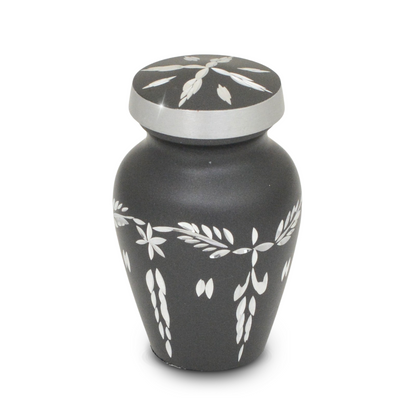 Pewter-finish keepsake urn covered in cut diamond facets that catch the light