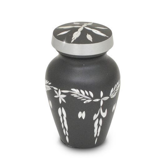Pewter-finish keepsake urn covered in cut diamond facets that catch the light