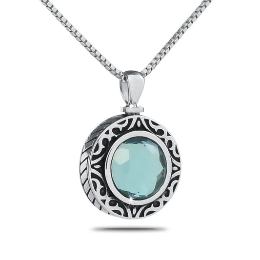 Round silver pendant with a pale blue green aquamarine coloured stone at its center
