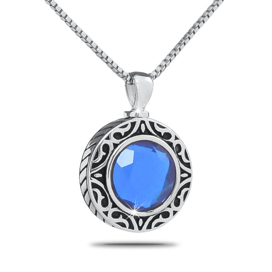 Stainless steel cremation pendant with a deep blue September birthstone at the center