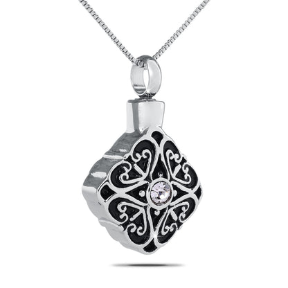 Silver cremation pendant with a clear faceted crystal set in a detailed openwork frame
