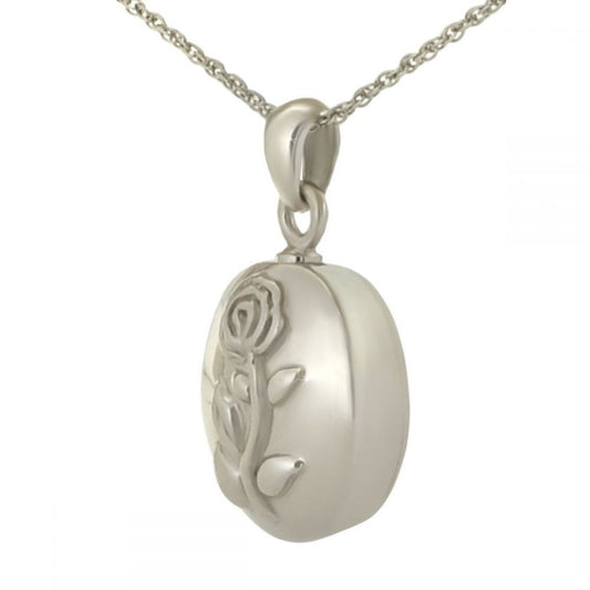Silver pendant with a raised rose in bloom on the front, petals layered in relief