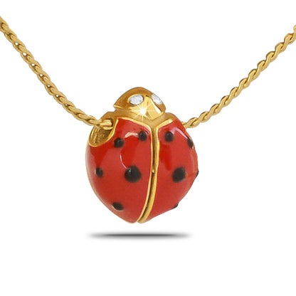 Gold-toned steel ladybug pendant with a rounded wing case and small spots on the back