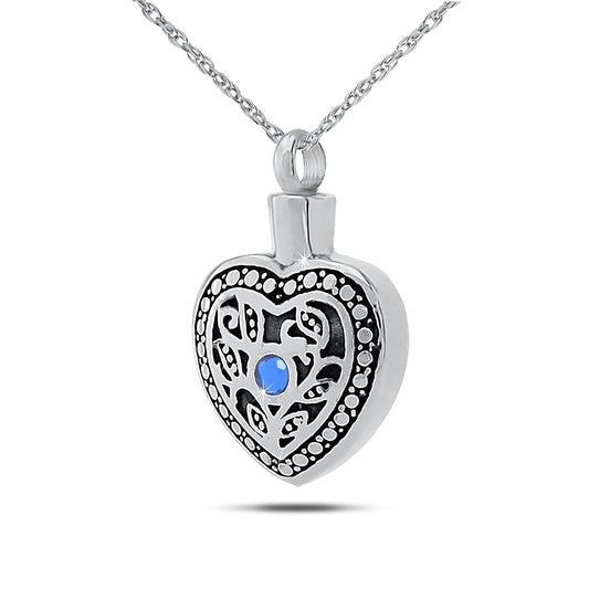 Stainless steel keepsake urn with a heart cutout and a deep blue sapphire-toned stone