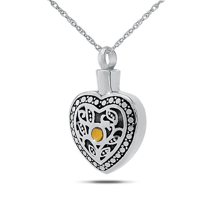 Round silver keepsake pendant with a golden-orange citrine stone at the centre
