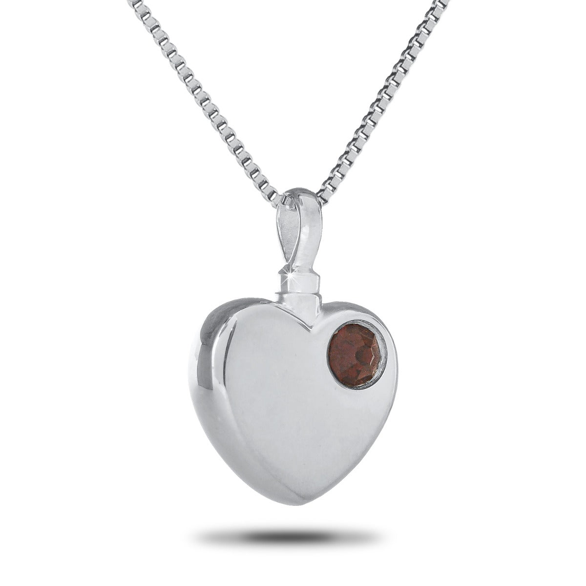 Polished steel heart keepsake urn with one red stone set into the upper curve