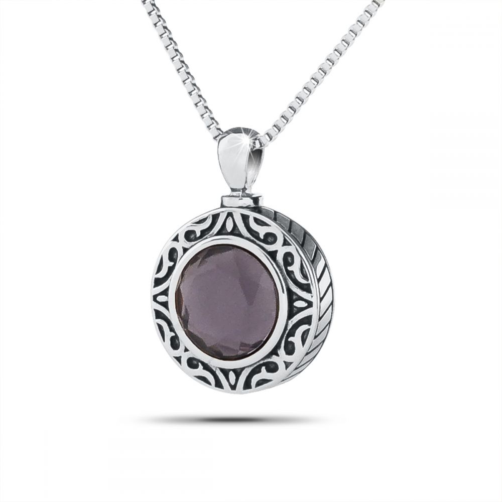 Small stainless steel keepsake with a domed royal purple stone and a polished silver rim