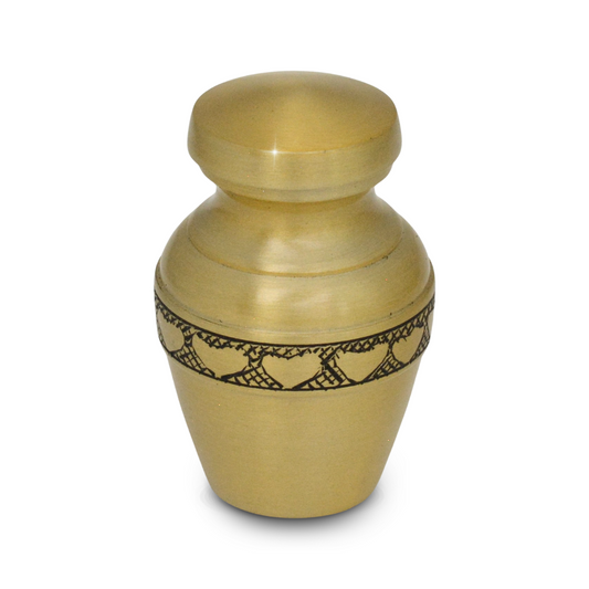 Wide brass keepsake urn with a low profile and a ring of hearts around the body