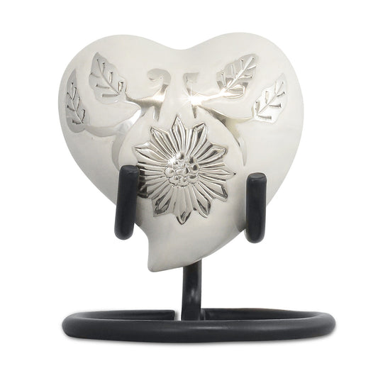White heart-shaped keepsake urn on a brass body with a smooth unbroken front
