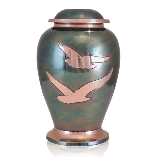 Polished brass cremation urn with two doves in flight worked into the front face