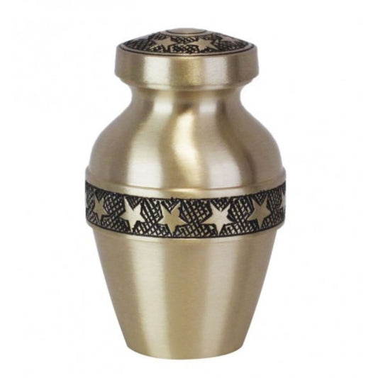 Narrow brass keepsake urn with a polished gold finish and small star motifs on the body