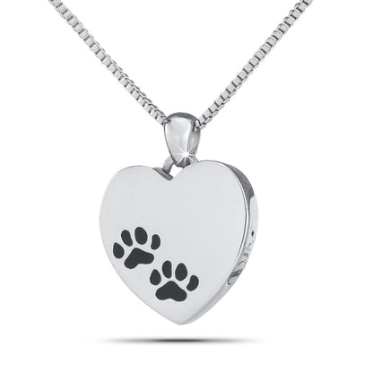 Silver heart-shaped pet keepsake with a raised paw print on the polished front