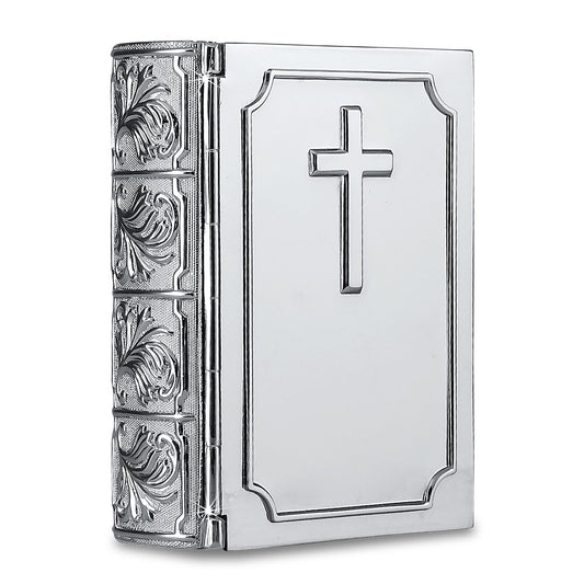 Small metal cremation urn shaped like a closed Bible, lying flat and book-like