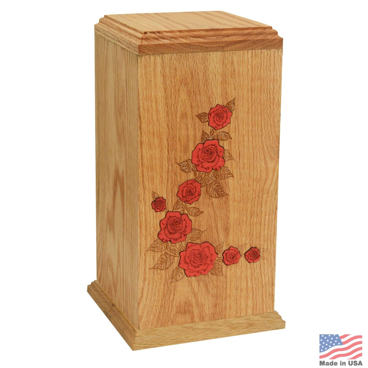 Tall pale oak column urn with a carved blossom design on the front face