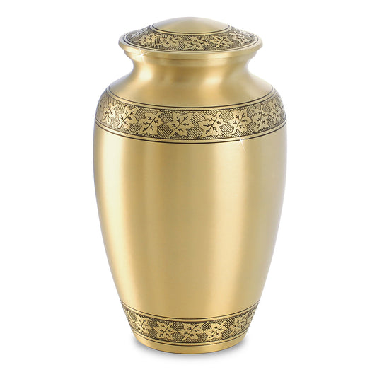Brass cremation urn with maple leaves engraved in a band around the body
