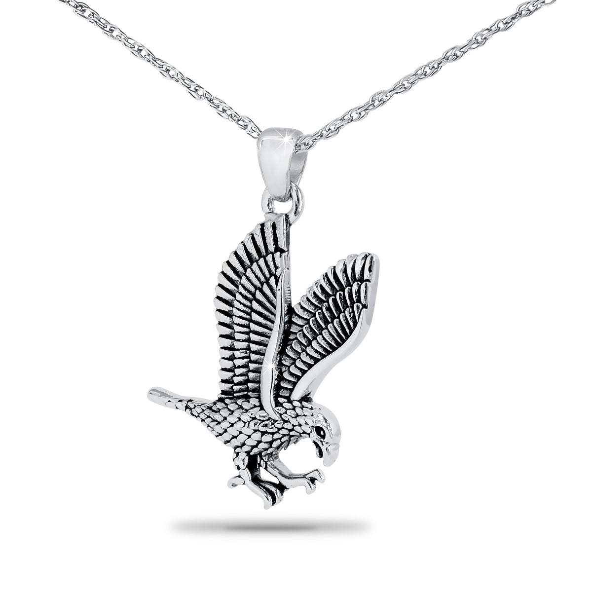 Silver pendant with an eagle worked in relief, slightly taller than it is wide