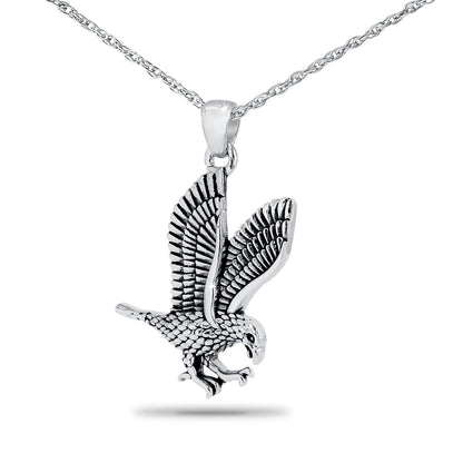 Silver pendant with an eagle worked in relief, slightly taller than it is wide