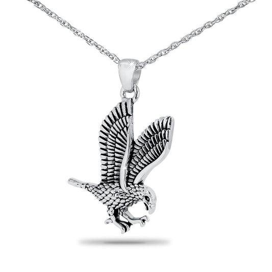 Silver pendant with an eagle worked in relief, slightly taller than it is wide