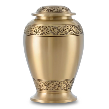 Polished brass cremation urn with long feather shapes worked across the body