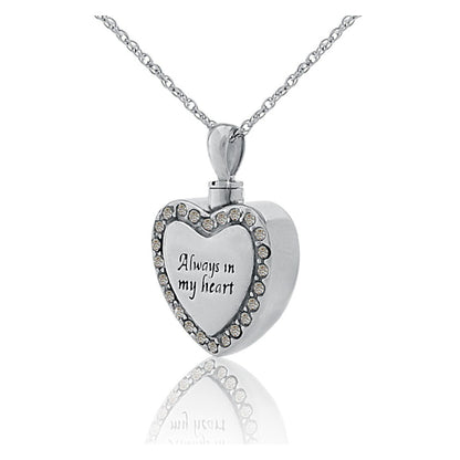 Silver heart pendant set with small white stones, hanging from a silver chain