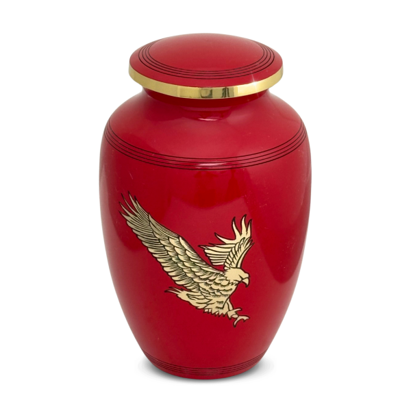 Red brass cremation urn with a raised bald eagle in flight on the front and a domed lid