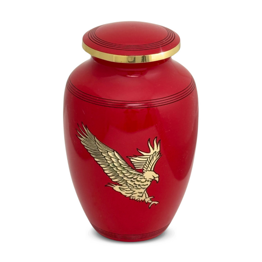 Red brass cremation urn with a raised bald eagle in flight on the front and a domed lid