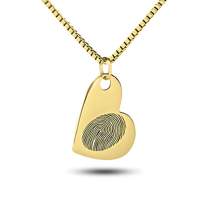 Flat polished gold heart pendant, slim profile, on a chain against a light background