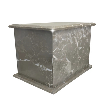 Wide, low cast stone cremation urn with a matte natural surface and no applied ornament
