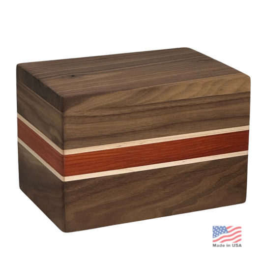 Walnut wood cremation urn with a peaked chalet-style lid and visible open grain
